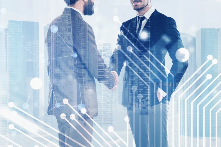 SaaS business professionals shaking hands during a technology partnership
