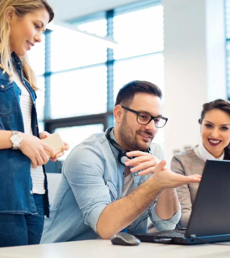 What your virtual assistant can handle every day with a team reviewing tasks on a laptop in an office